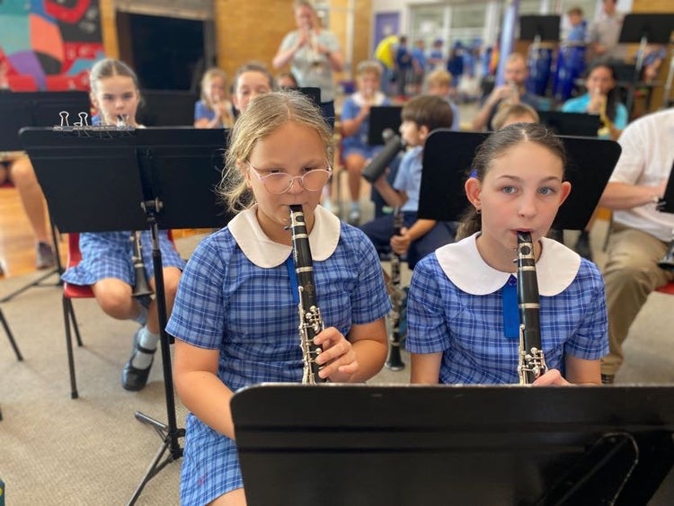 2 girls playing musical instruments